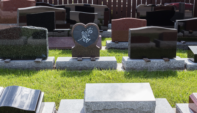various granite headstones on display in different styles and colors